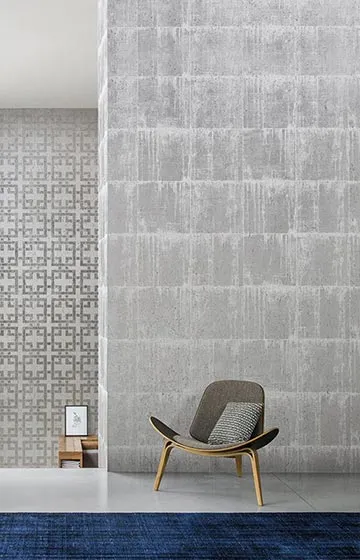 Elegant modern interior feature wall designed by Aces Design Studio in Gżira, Malta, showcasing textured wall finishes, designer lounge chair, premium decorative surfaces, minimalist styling, and contemporary residential interior design with timeless aesthetics.